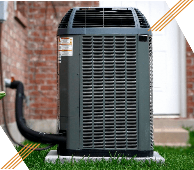 A picture of an air conditioner outside on the grass.